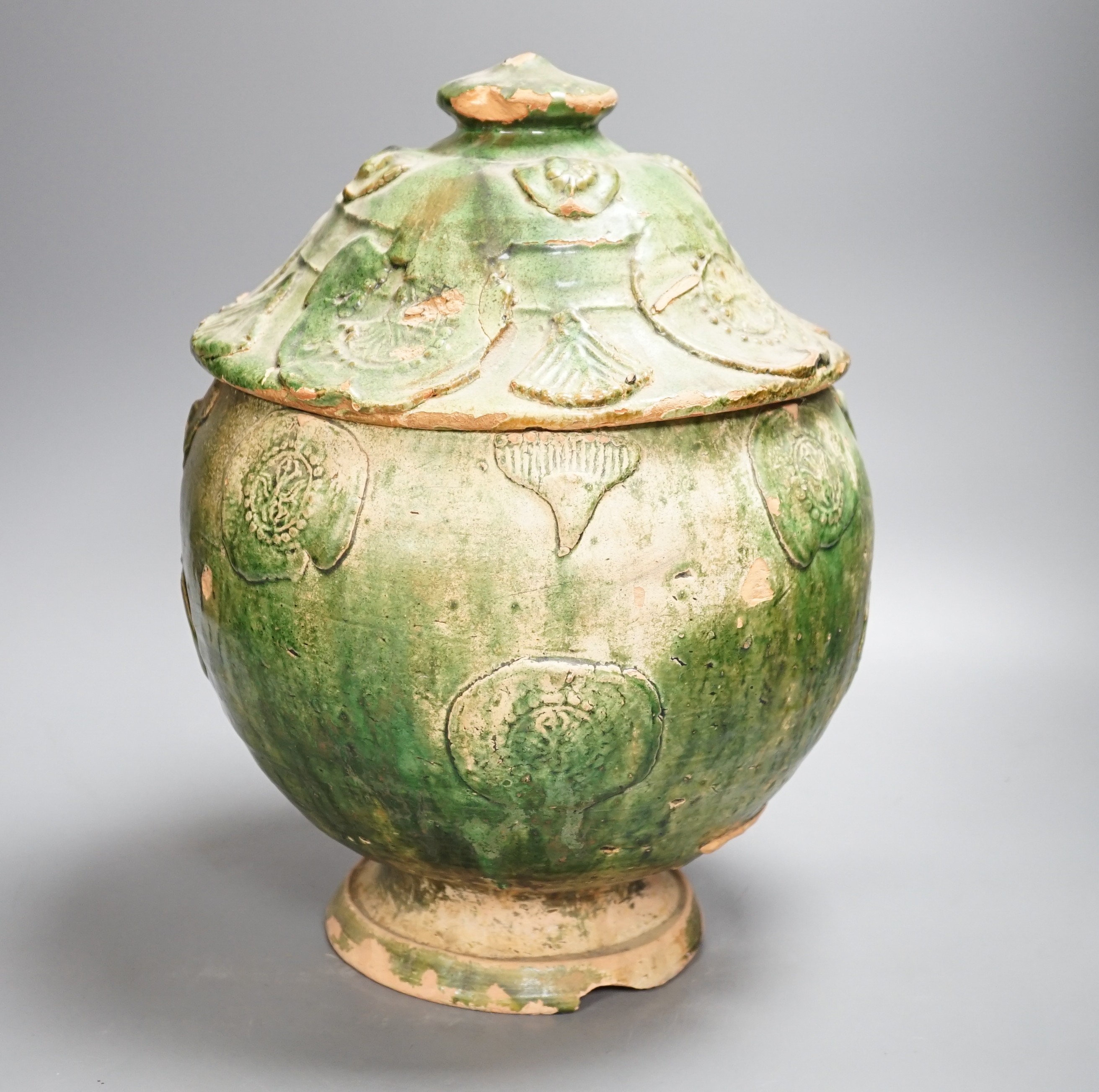 A large Chinese green glazed jar and cover, Liao dynasty, 35cm high